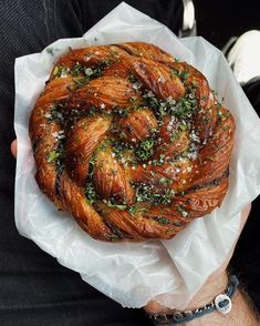 a person holding a pastry in their hand