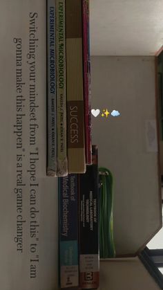 a stack of books sitting on top of a shelf