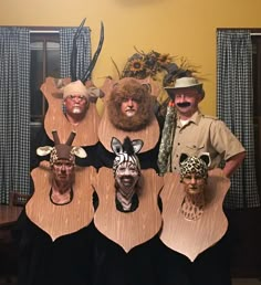 several people wearing animal masks in front of a table