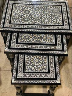 three tables with black and white designs on them