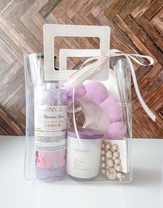 a pink teddy bear sitting in a clear bag next to a bottle of lotion