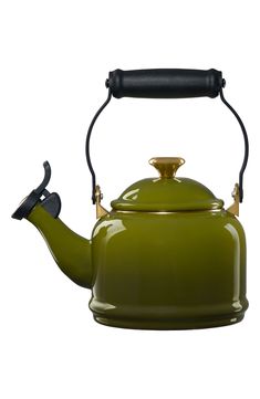 a green tea kettle with a black handle