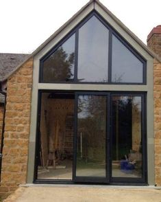 an image of a house that is being built with glass doors and windows on the outside