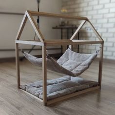 a house shaped like a hammock in a living room with wood flooring