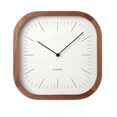 a wooden clock with white face and black hands