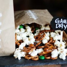 a bag full of popcorn and pretzels with a game day sign on it