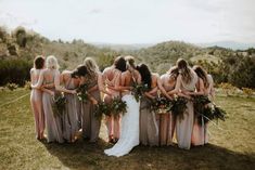 a group of women standing next to each other on top of a lush green field