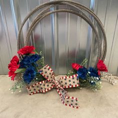 a patriotic wreath with red, white and blue flowers