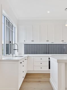 an empty kitchen with white cabinets and wood flooring is pictured in this image from the inside