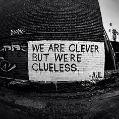 a sign on the side of a building that says we are clever but were clueless