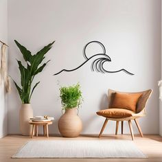 a living room with two chairs and a potted plant on the floor in front of a white wall