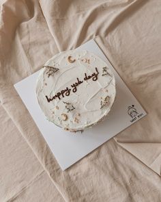 a birthday cake sitting on top of a white card that says happy birthday to you