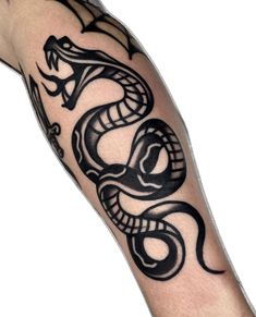 a man's arm with a black and white tattoo design on it, featuring a snake