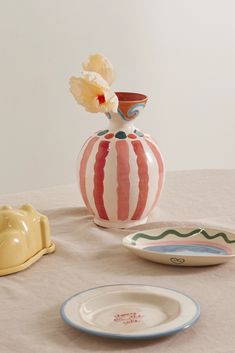 two plates and a vase on a table