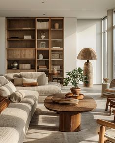 a living room filled with furniture and large windows