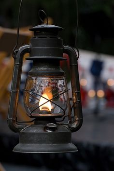 an old fashioned lantern with a lit candle inside