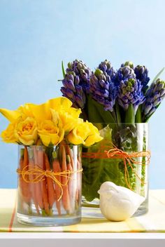 a vase filled with lots of flowers next to a garlic and an onion on top of a table