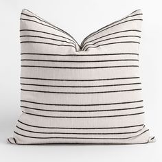 a black and white striped pillow on a white background