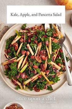 kale apple and pancetta salad on a plate with two bowls of nuts