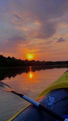 the sun is setting on the water from a kayak