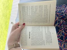 a person holding an open book in their hand