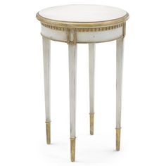 a small white table with gold trimmings