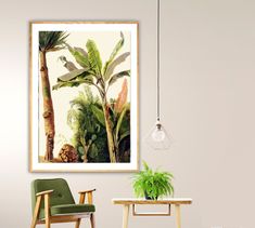 a chair and table in a room with a painting on the wall above it that has a palm tree