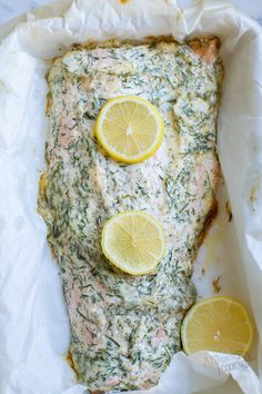 the fish is covered with herbs and lemons