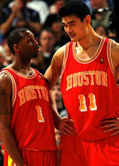 two basketball players standing next to each other