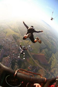 a man flying through the air while riding a parachute