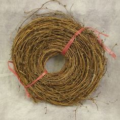 a coil of twine with pink ribbon tied around it