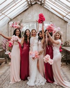 a group of women standing next to each other in front of a glass ceilinged room