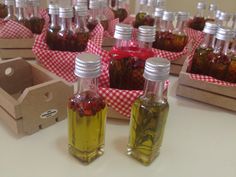 several small bottles filled with liquid sitting on top of a table next to some boxes