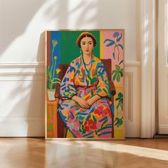 a painting is sitting on the floor in front of a white wall and wooden floors