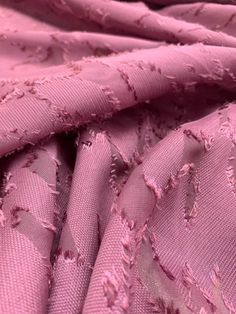 the fabric is pink and has holes in it