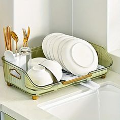 there is a tray with plates and silverware in it on the kitchen countertop