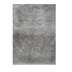 an area rug with grey fur on it