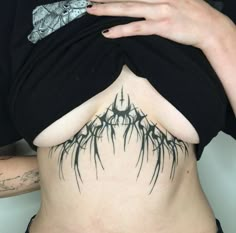 a woman with black tattoos on her stomach