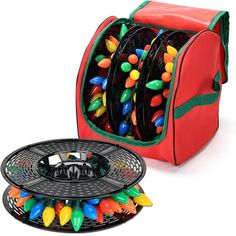 a red bag filled with lots of different colored candy beads next to a black plate