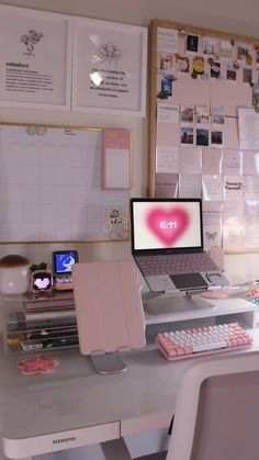 a laptop computer sitting on top of a desk next to a keyboard and mouse pad