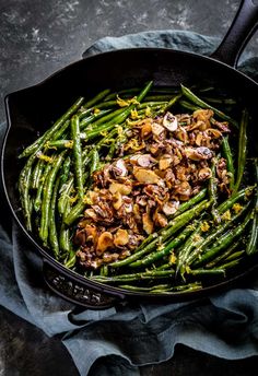 a skillet filled with green beans and mushrooms