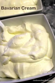 two bowls filled with white cream on top of a table