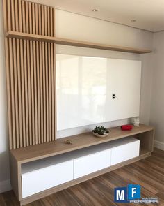 an empty room with a large mirror on the wall and wooden shelves in front of it