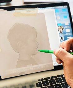 a person is drawing on a computer screen