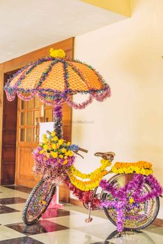 a bicycle decorated with flowers and an umbrella