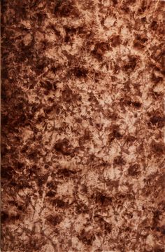 a brown area rug is shown in the middle of an image, with dark spots on it