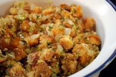 a white bowl filled with stuffing and vegetables