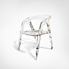 a clear plastic chair sitting on top of a white floor