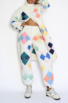 Made for cooler weather and featuring a patchwork pattern of our original tile prints, the Ada Quilted Joggers can be worn alone or with our Vera Quilted Coat of the same design. Intricately designed Patches print Soft matte quilted fabric Stretch waistline and cinch at ankle Secure front pockets and front zipper closu Quilted Overalls, Quilt Pants, Quilted Joggers, Quilted Scarf, Quilt Clothes, Quilted Pants, Quilted Coats, Quilting Fashion, Patchwork Clothing