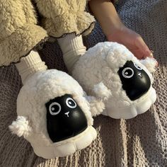 a pair of black and white sheep slippers